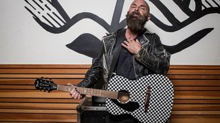 Tim Armstrong holds his new signature Fender Hellcat guitar
