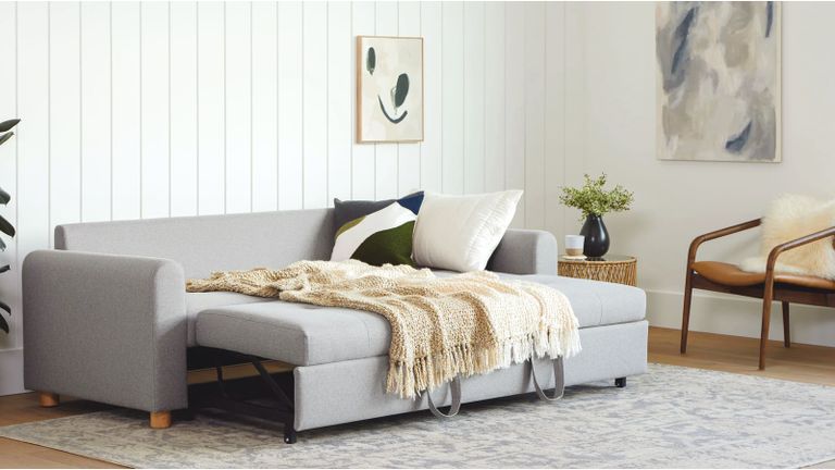 A grey sofa bed in a modern living room