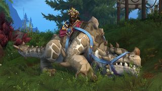 WoW 10.2.5 update - a player is sitting on top of a large dinosaur mount