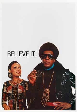 A poster with a black female and black male and the phrase BELIEVE IT behind.