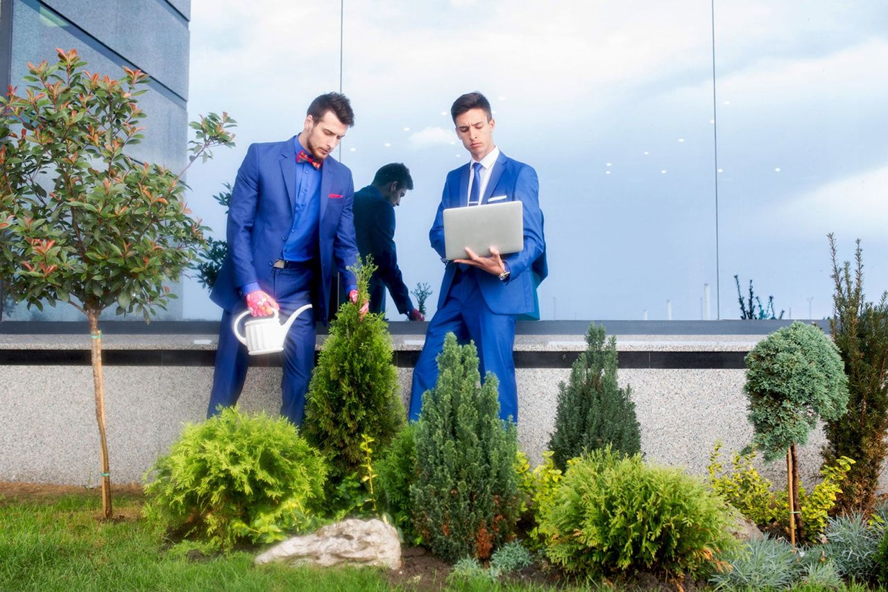 Corporate Workers Watering Garden At Work