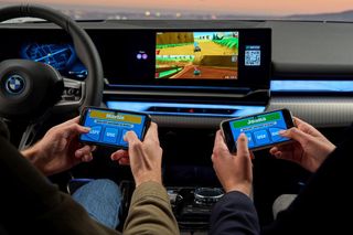 Two players playing a video game in a BMW dashboard console