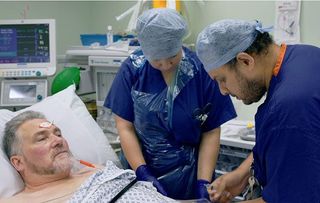 Consultant Anaesthetist Khalid Hasan prepares Chris for his operation