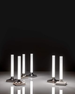 Minimalist portable light by Philippe Starck for Kartell, with square metal base and straight LED cylinder