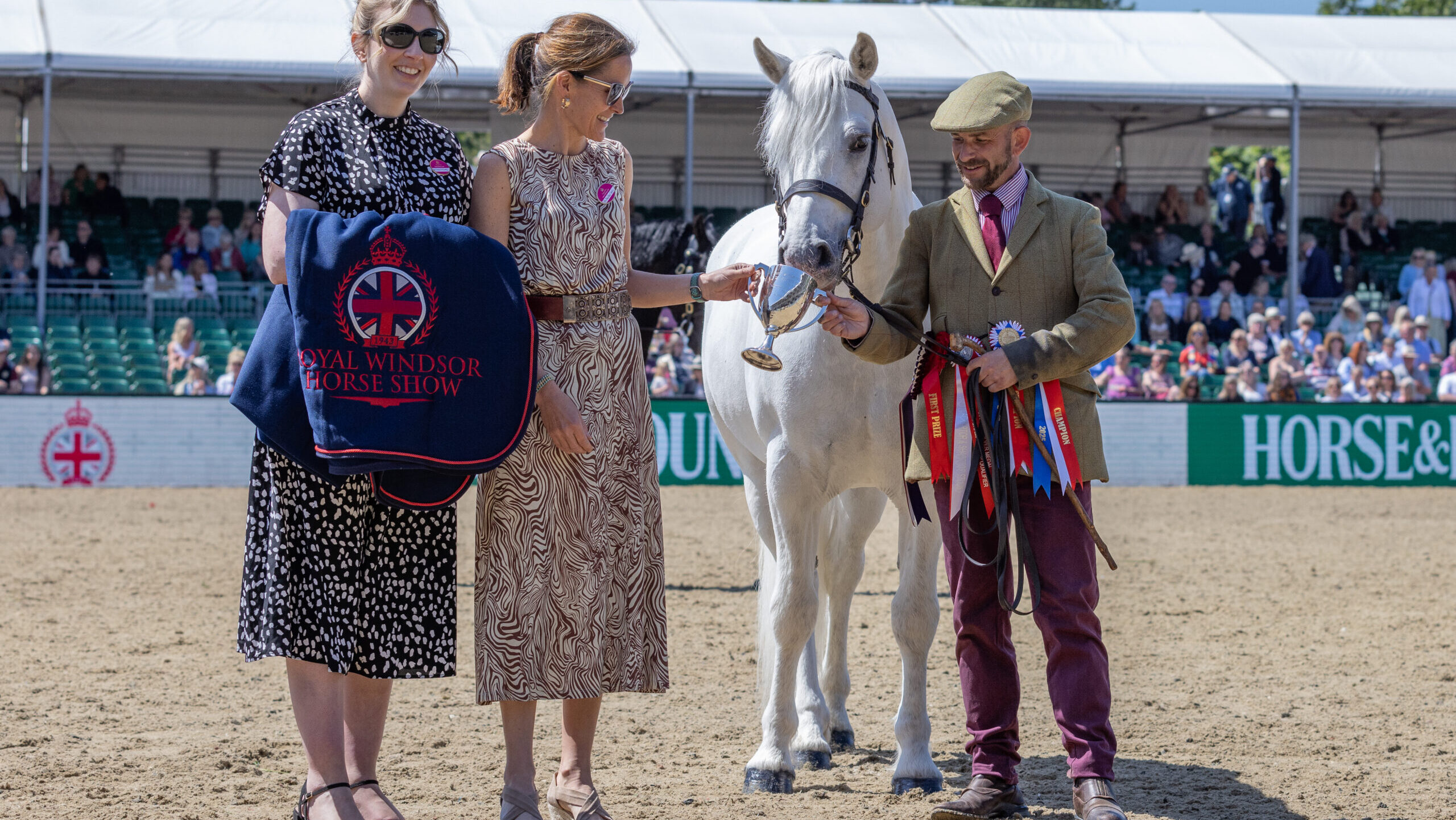 Connemara Clover Hill Magic and handler Jamie Frost are presented with the overall M&amp;amp;M in-hand championship at Royal Windsor Horse Show