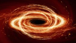 An illustration of a black hole with golden light swirling around its event horizon.