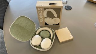 Sonos Ace noise-cancelling headphones in open case next to packaging