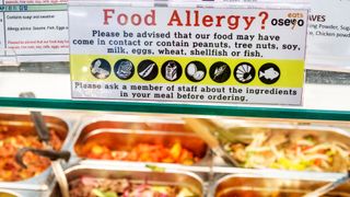 un semn ilustrat deasupra unui bufet de alimente calde scrie
