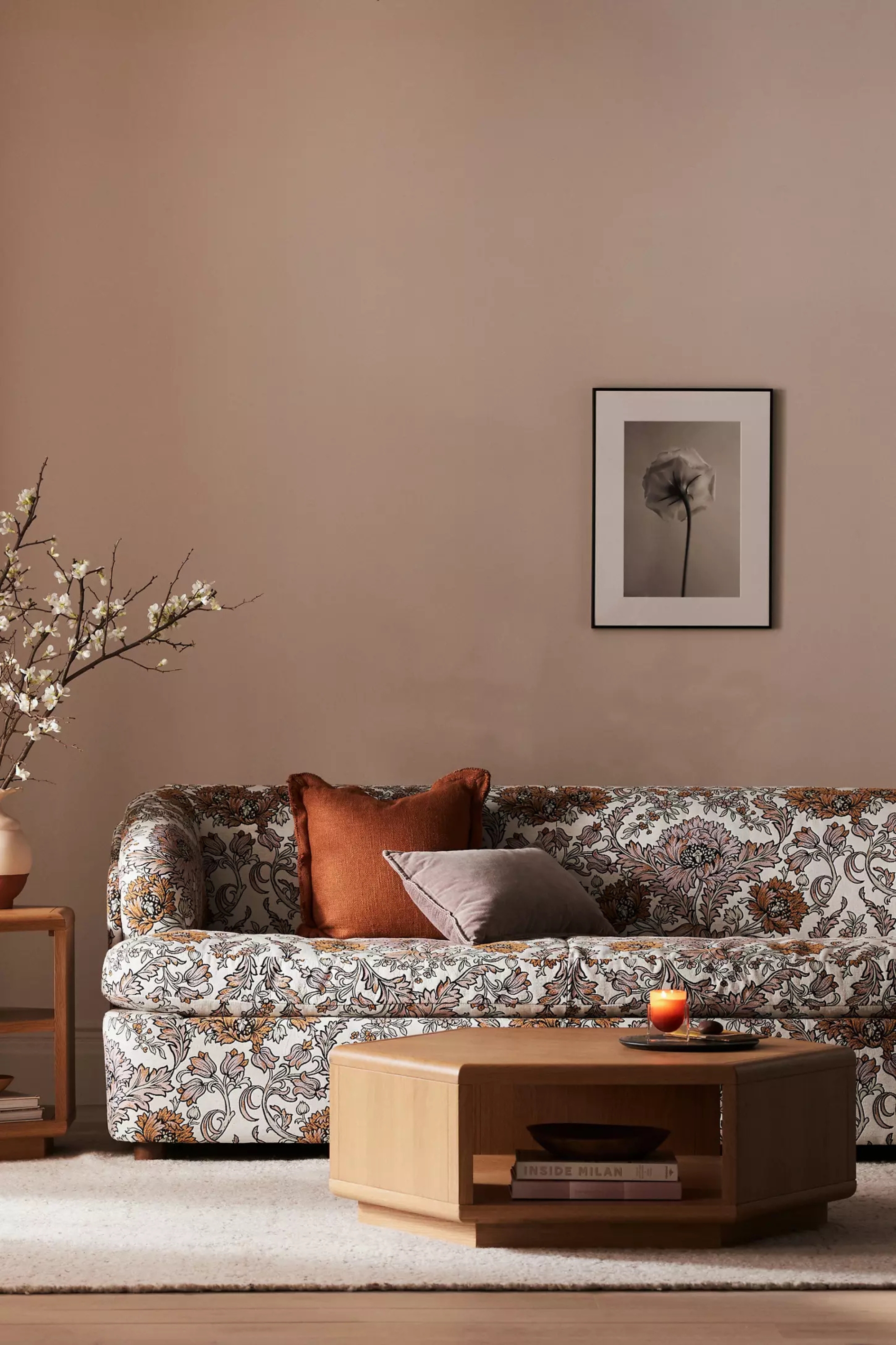 a patterned sofa in a living room with plaster walls