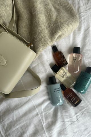 M&S perfumes shot as a group with a cream YSL handbag