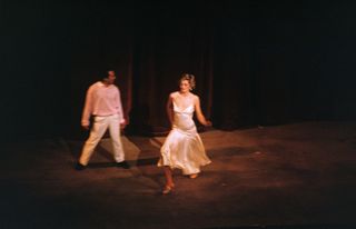 Princess Diana wearing a white slipdress and Wayne Sleep dancing on stage in 1985