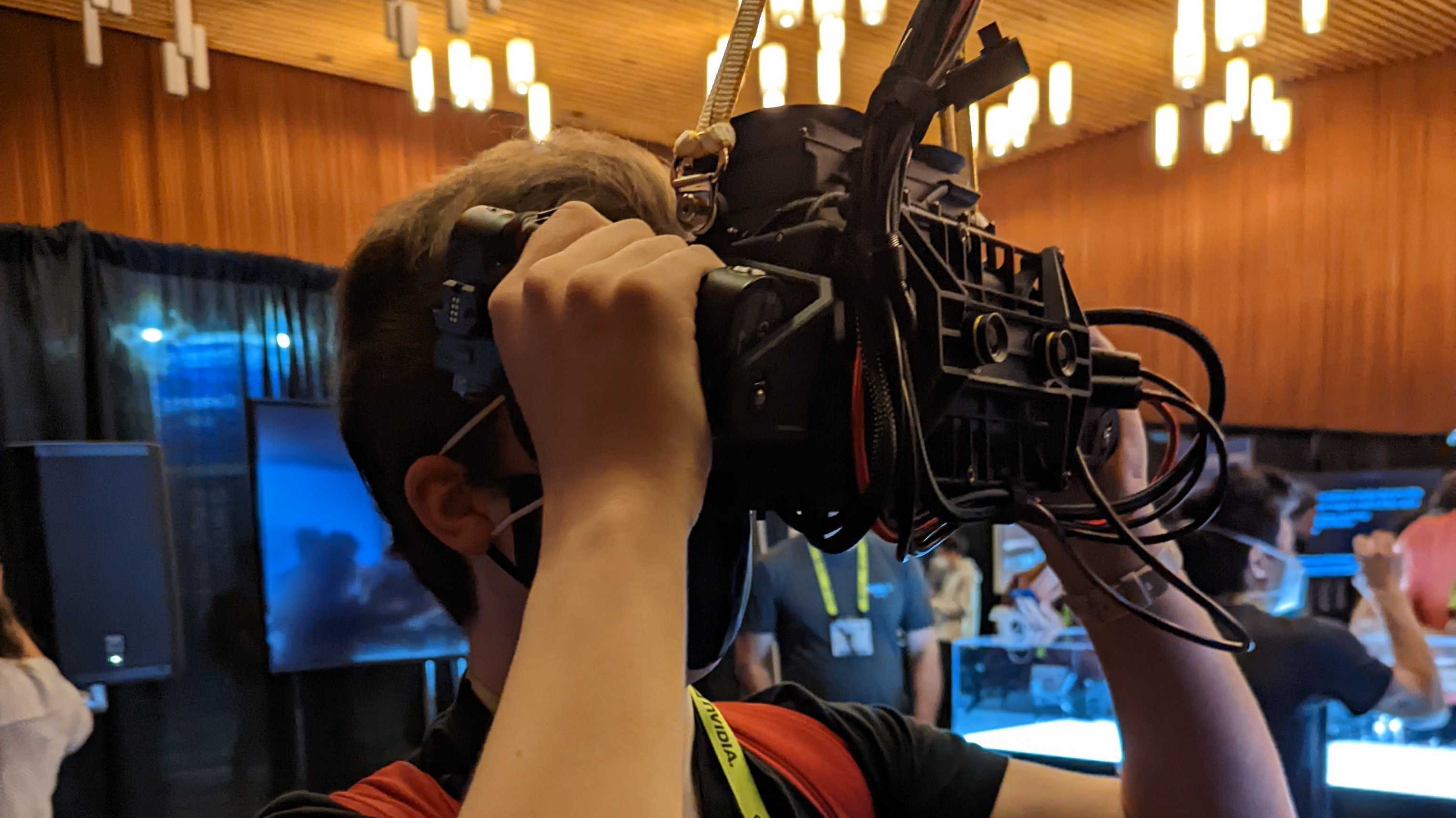 A person holding a Starburst VR headset up to their face