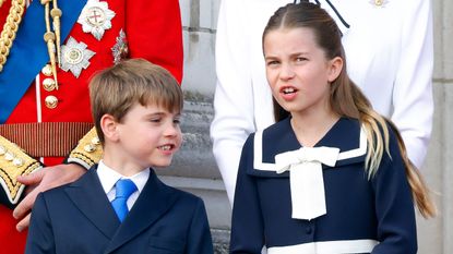 Prince Louis of Wales and Princess Charlotte of Wales watch an RAF flypast from the balcony of Buckingham Palace 