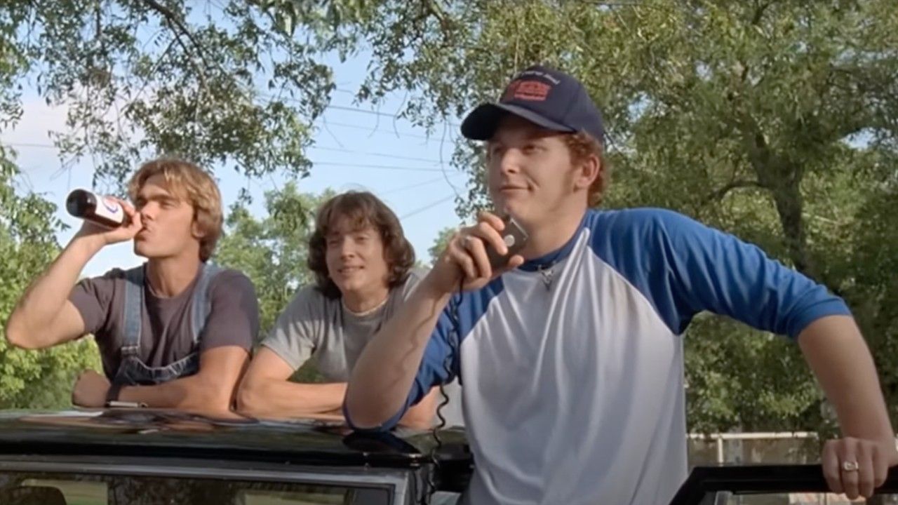 Cole Hauser speaking into a car microphone in Dazed and Confused with two pals.
