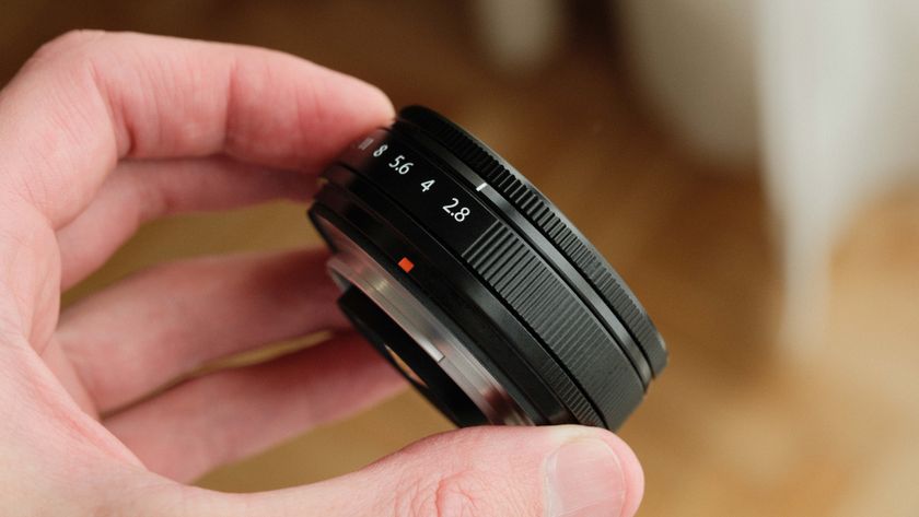 Fujifilm XF 23mm f/2.8 R WR lens held in a hand