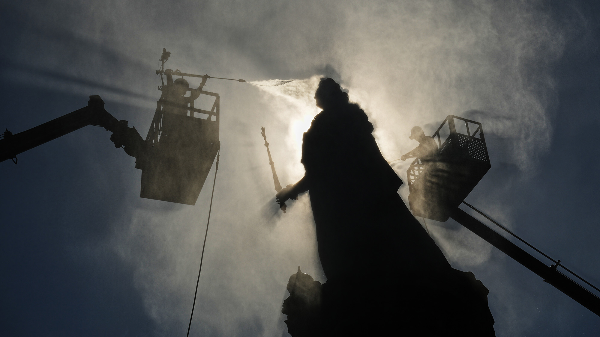 Employees of the Museum of Urban Sculpture clean the statue of Catherine the Great in St. Petersburg, Russia