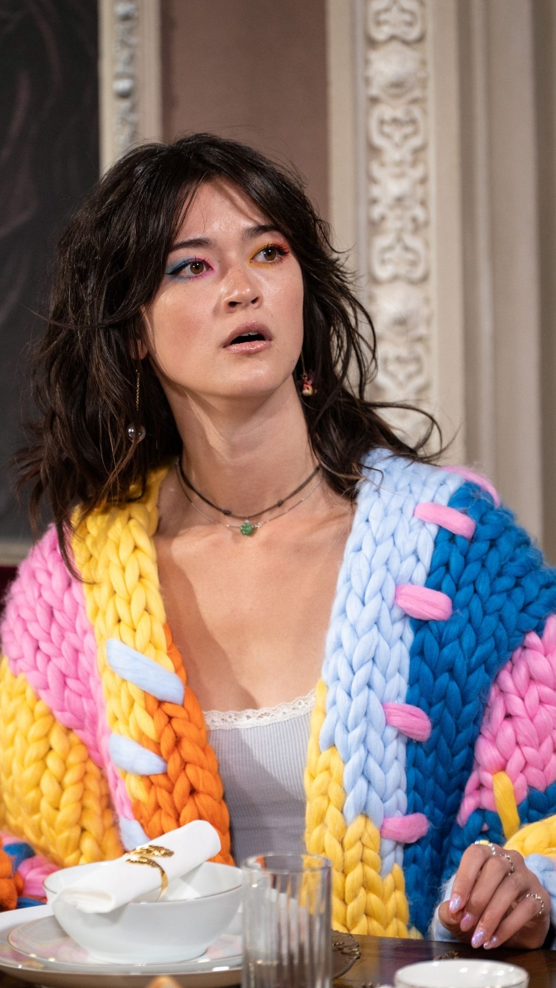 jade from the traitors wearing a bright cardigan