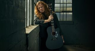 Dave Mustaine holds his new signature Gibson Songwriter acoustic guitar