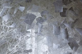 View of the sheet music and white thread at Chiharu Shiota’s ‘Beyond Time’ exhibition at Yorkshire Sculpture Park