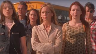 The Buffy the Vampire Slayer cast stand together outside in the daylight in the series finale.