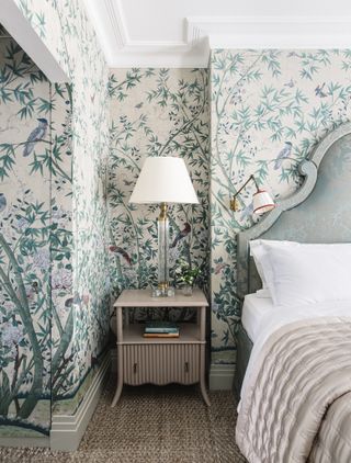 Blue bedroom with blue velvet headboard and wallpaper