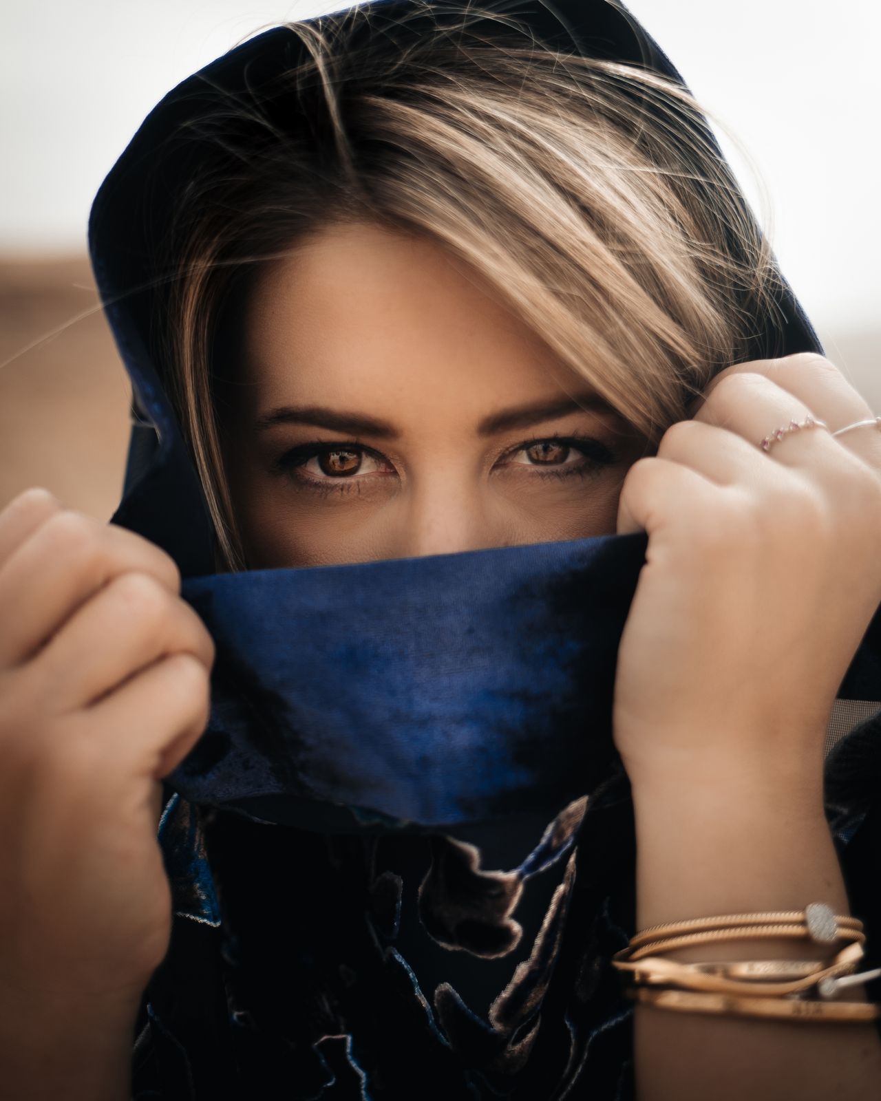A female looking out from a scarf