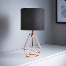 black copper geo lamp on white wooden board