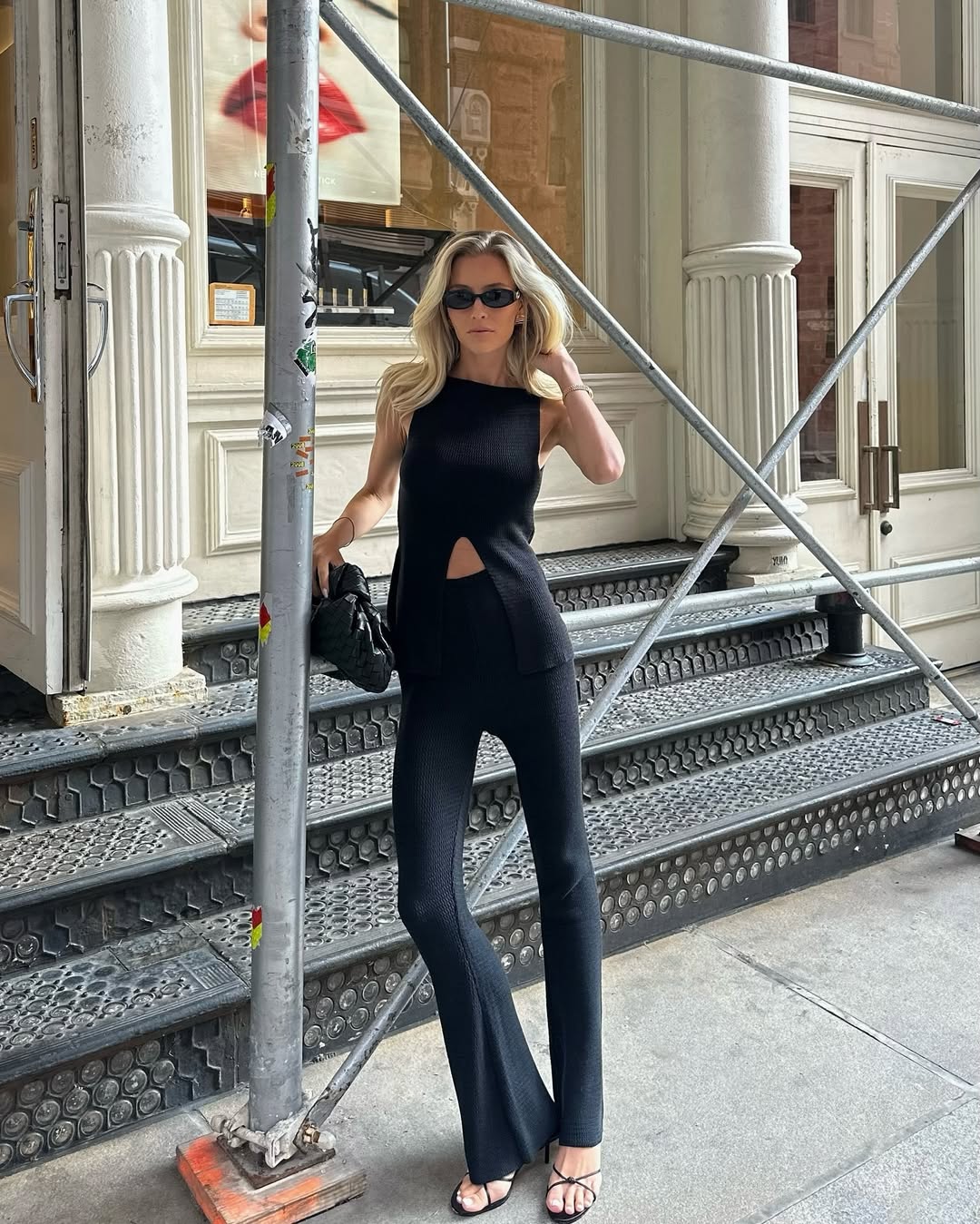 woman wearing black flare pants and black top