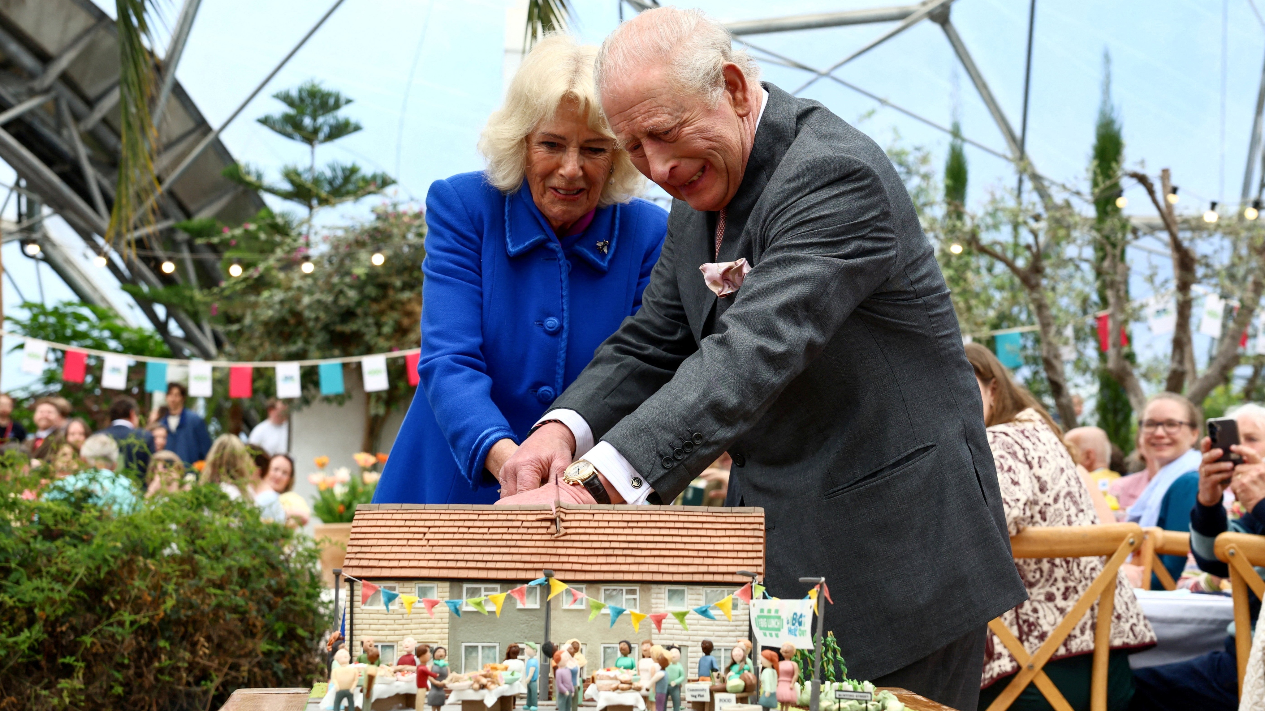 King Charles and Queen Camilla cut a commemorative cake to mark the 25th anniversary of The Eden Project in Bodelva, Cornwall