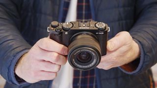 Fujifilm X-M5 camera with 15-45mm lens, in the hand