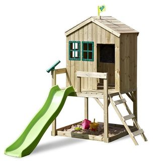 TP FSC Forest Cottage brown playhouse on stilts, sandbox underneath and green slide leading to the ground from the deck, with other green features such as windows and telescope