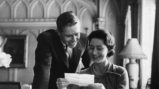 Princess Margaret and her fiancee Anthony Armstrong-Jones reading telegrams of congratulations after the announcement of their engagement.