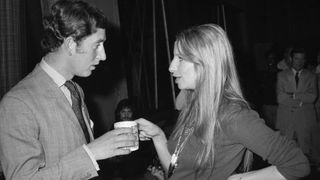Prince Charles and singer Barbra Streisand share a moment over coffee at Warner Bros. studio on March 19, 1974 in Los Angeles, California.