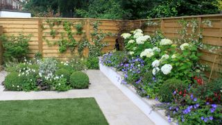wooden hit and miss fencing in landscaped garden
