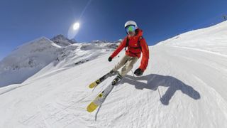 A GoPro HERO8 Black is used to film a person skiing down a mountain