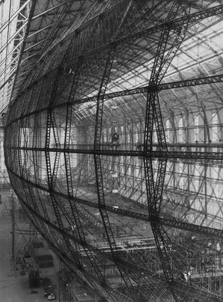 The vast and intricate framework of the new Zeppelin LZ 129 under construction at Friedrichshafen, Germany, in October 1934.With a gas capacity of 7,070,000 cubic feet, "The Hindenburg" became largest airship in the world.