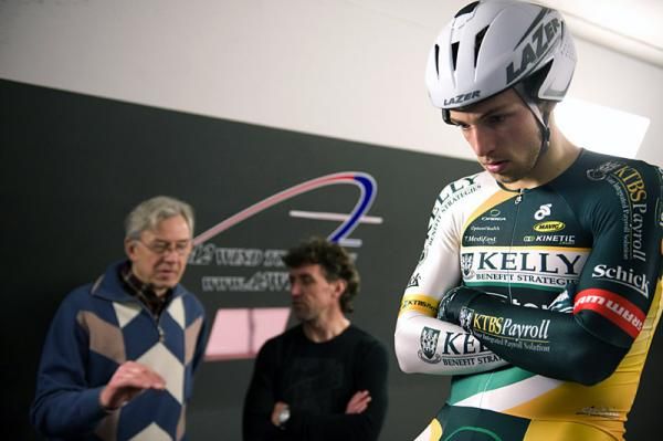 David Veilleux focuses while his coach Pierre Hutsebaut, left, and aerodynamics consultant Tim Mulrooney discuss his position.