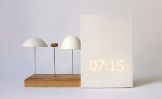 Alarm clock, speakers and radio photographed against a white background
