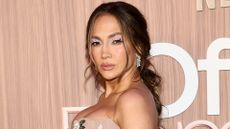 Jennifer Lopez is pictured with her hair in a low ponytail and wearing a nude, floral-embellished dress at Netflix's "Office Romance" New York Premiere at Regal Union Square on June 02, 2026, in New York City.