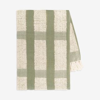 green and cream textured throw blanket