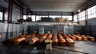 An image showing 35 coffins stored in a warehouse in Ponte San Pietro, near Bergamo, Lombardy, Italy, on March 26, 2020, prior to be transported to another region to be cremated during the COVID-19 pandemic.