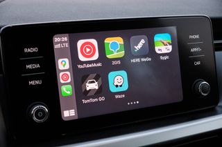 apple carplay screen with apps including youtube music and waze