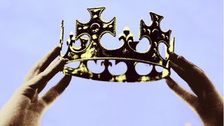 Hands holding up a crown