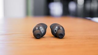 Samsung Galaxy Buds FE wireless earbuds held in the hand.