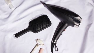 ghd Helios lifestyle shot with hairbrush
