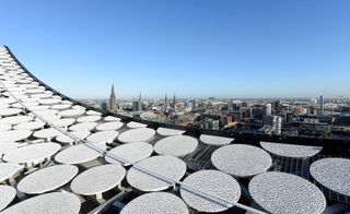 View of the city from the roof top of the Elbphilharmonie. The roof is covered with textured circular panels.