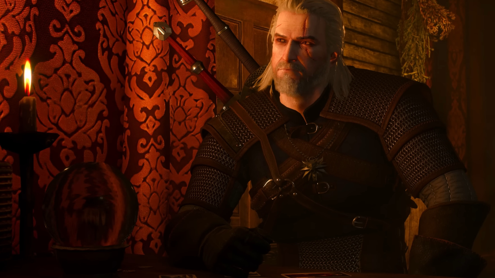 Geralt sitting in a red room during the RPG The Witcher 3: Wild Hunt