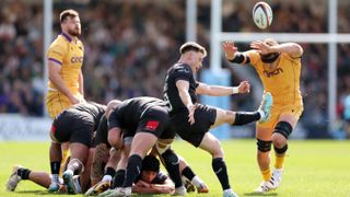 Stephen Varney of Exeter Chiefs kicks under pressure from Tom Lockett of Northampton Saints during the Gallagher PREM match between Exeter Chiefs and Northampton Saints