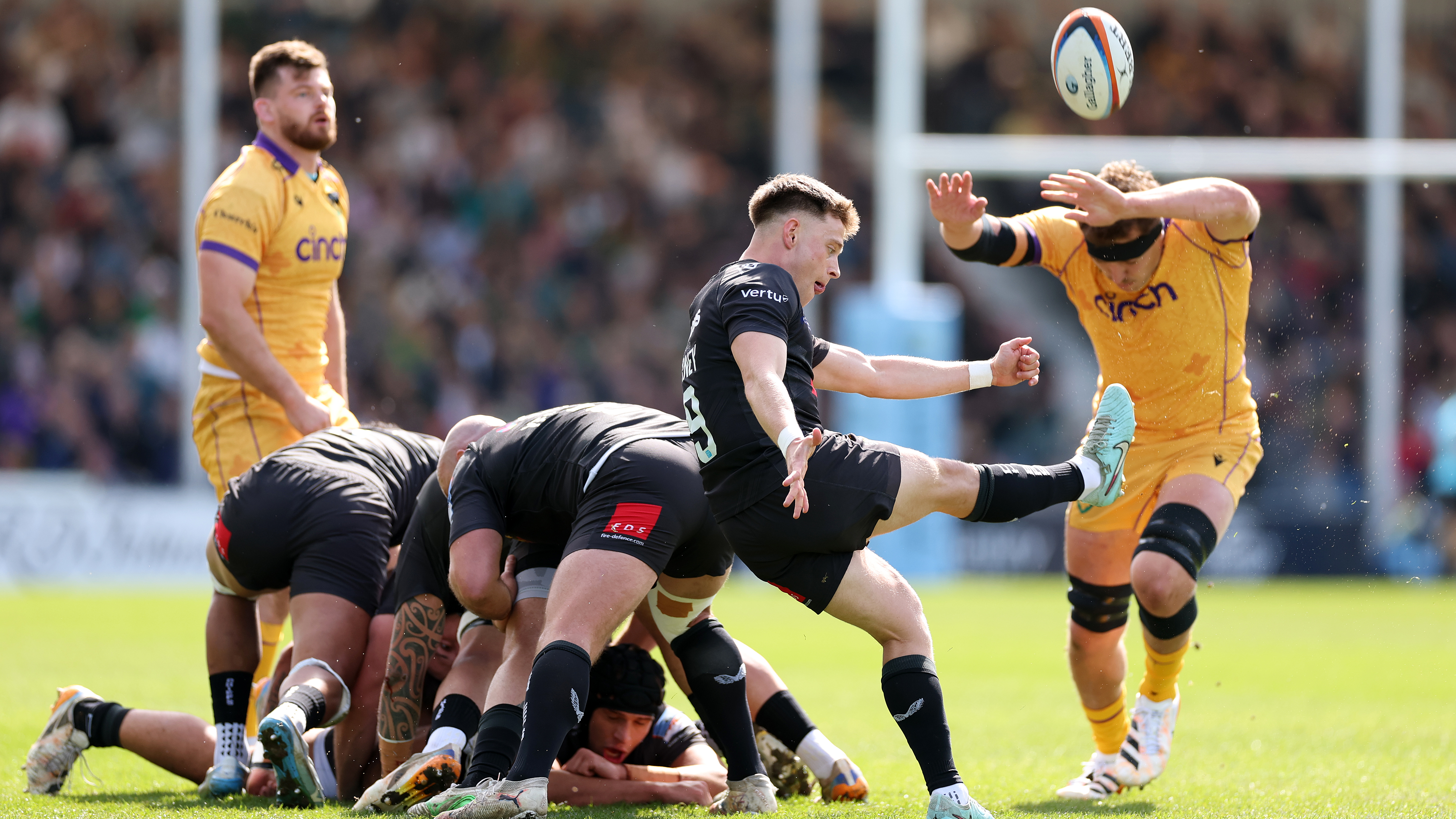 Stephen Varney of Exeter Chiefs kicks under pressure from Tom Lockett of Northampton Saints during the Gallagher PREM match between Exeter Chiefs and Northampton Saints