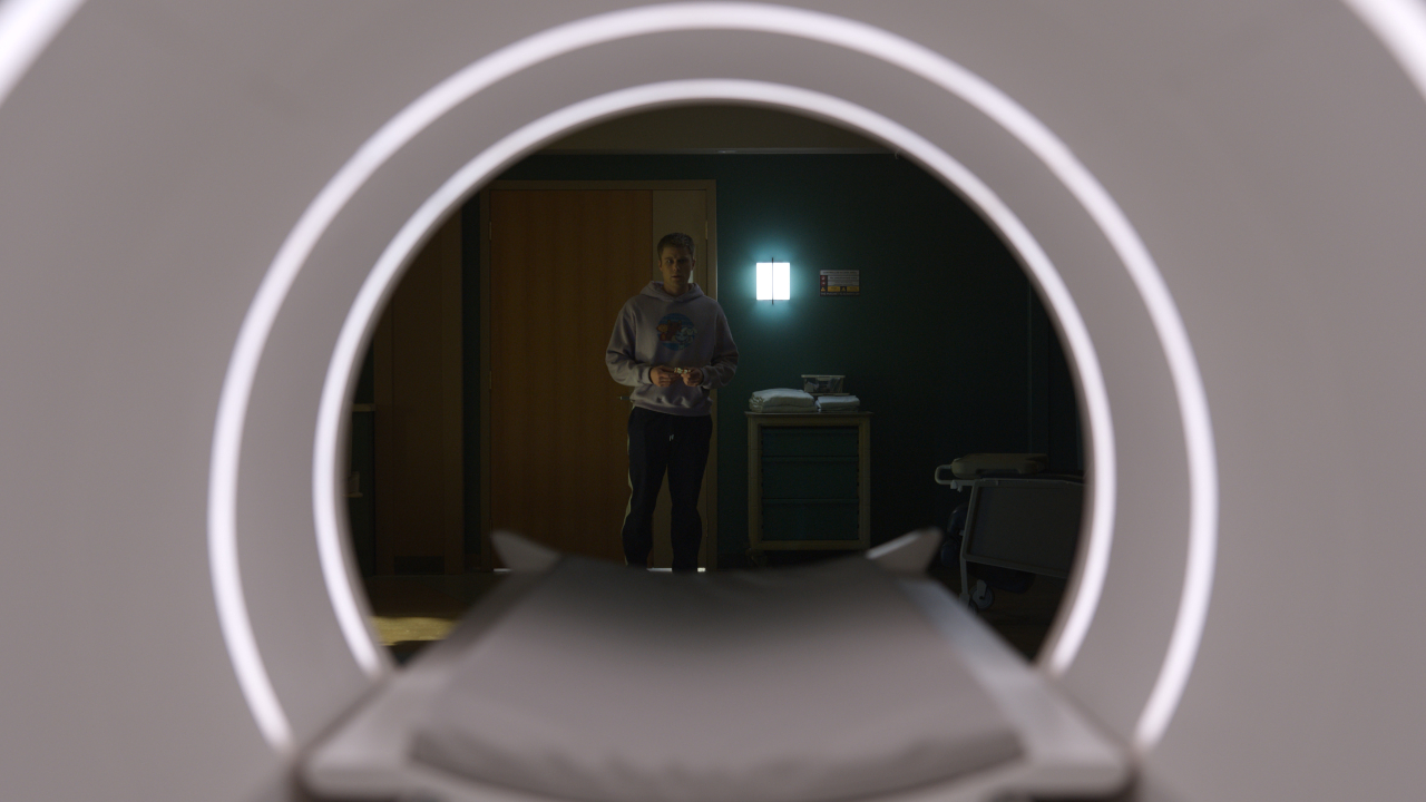 Owen Joyner stands looking intensely at an MRI machine in Final Destination Bloodlines.